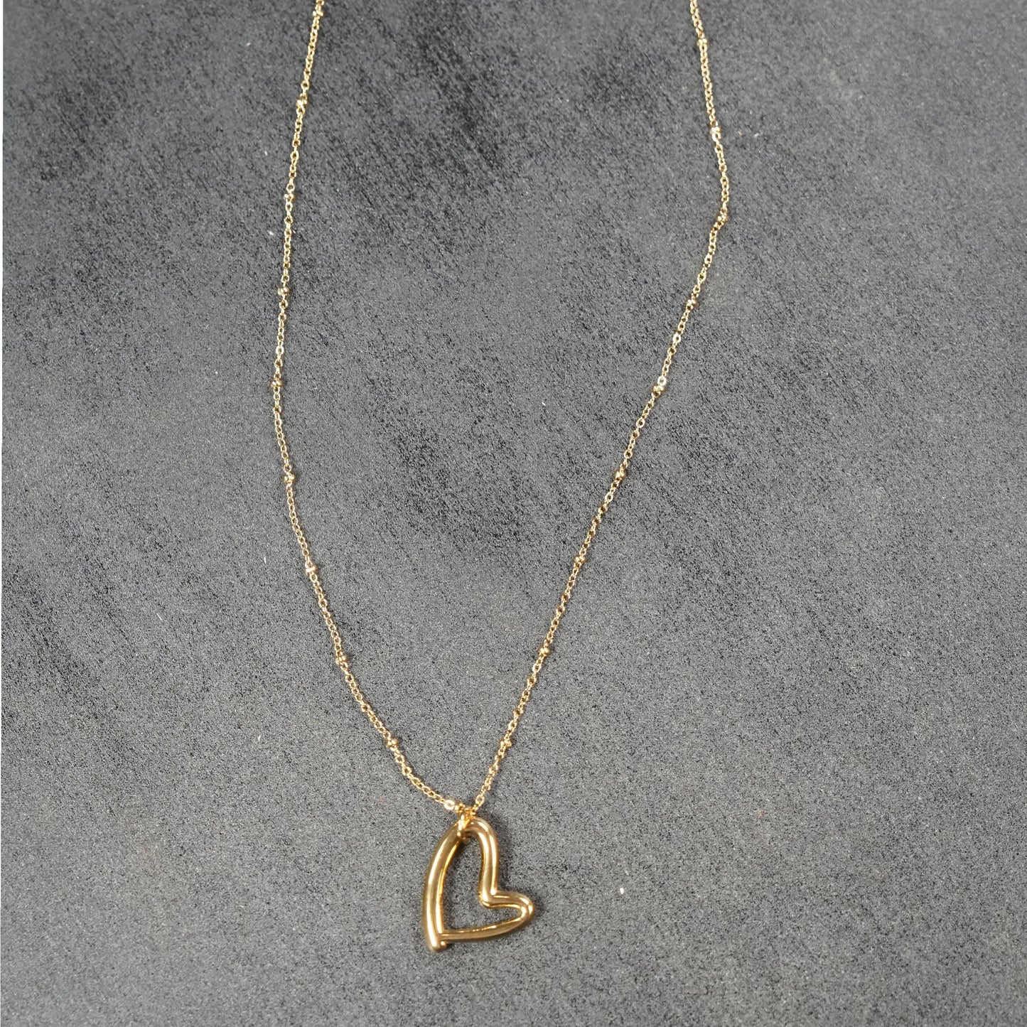 Dainty Beaded Chain Anchoring an Abstract Heart Shaped Pendant